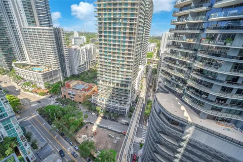 a kitchen with granite countertop a refrigerator and a sink