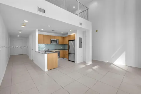 a view of kitchen with stainless steel appliances granite countertop a refrigerator and a sink