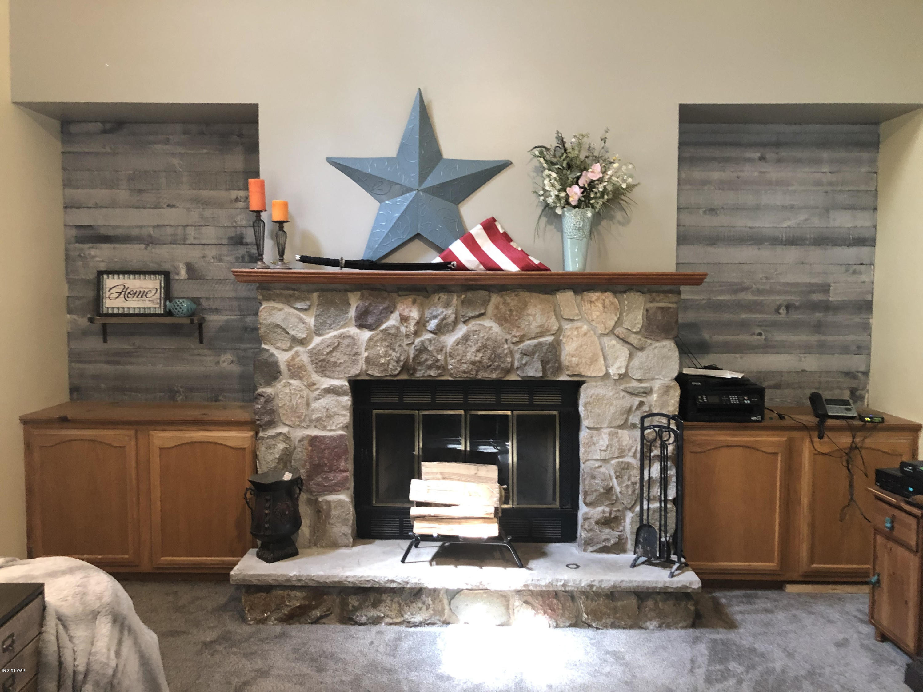 110 Weasel Road Dingmans Ferry, PA 18328 - Photo 20 of 39 a living room with furniture and a fireplace
