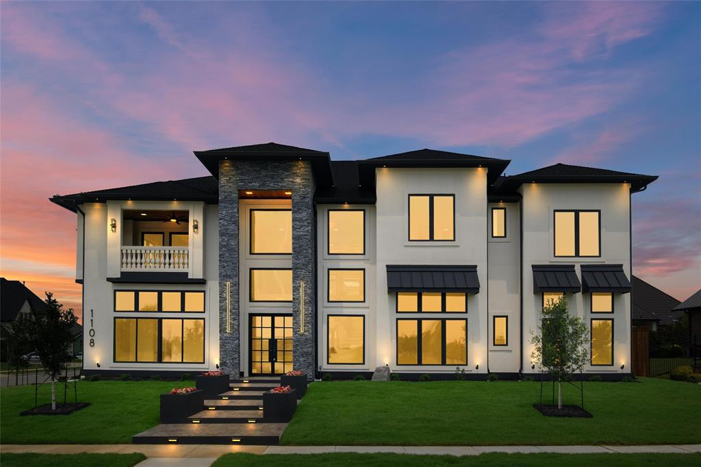 a front view of brick house with a yard