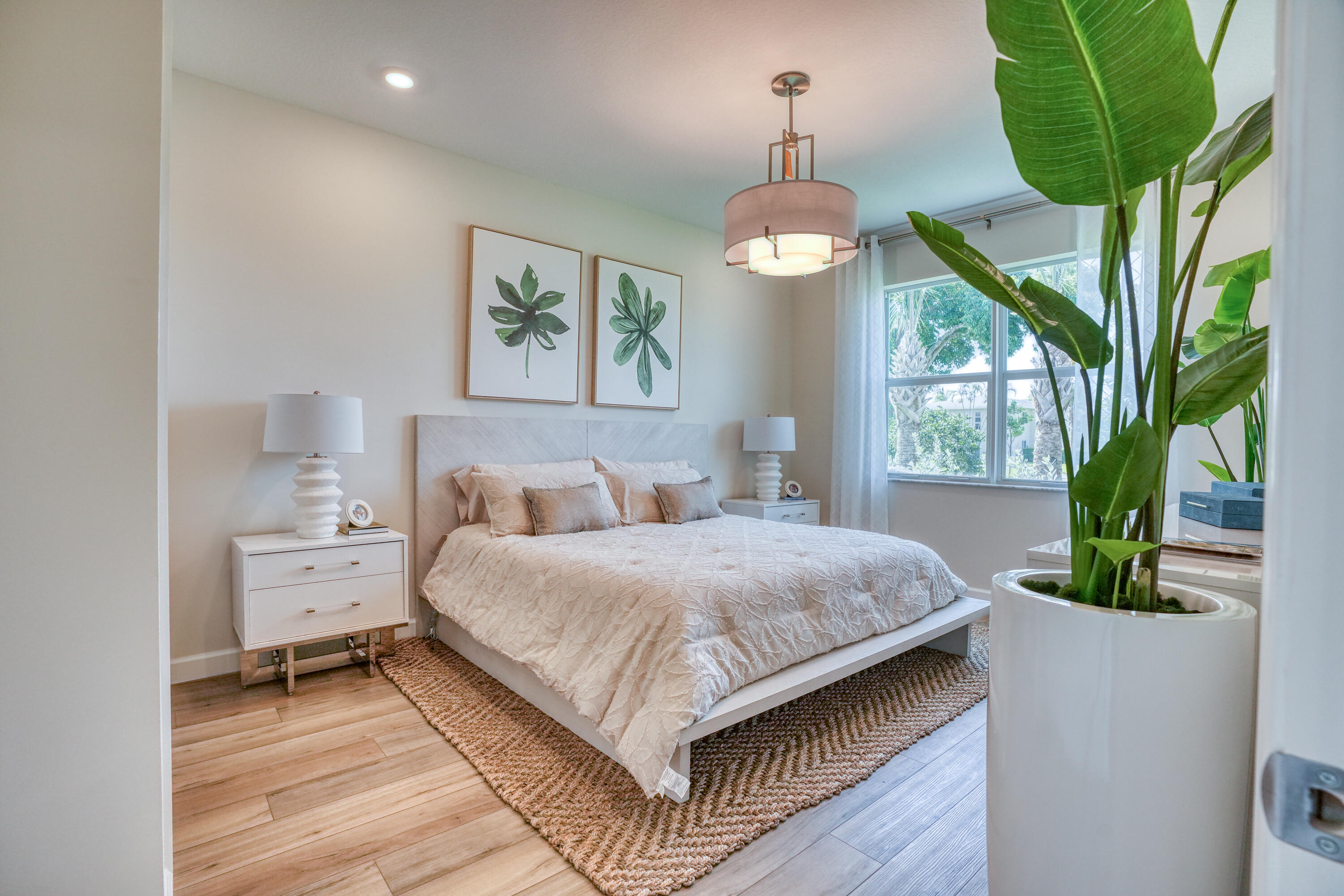 13659 Hero Path Delray Beach, FL 33484 - Photo 6 of 13 a spacious bedroom with a bed and a chandelier