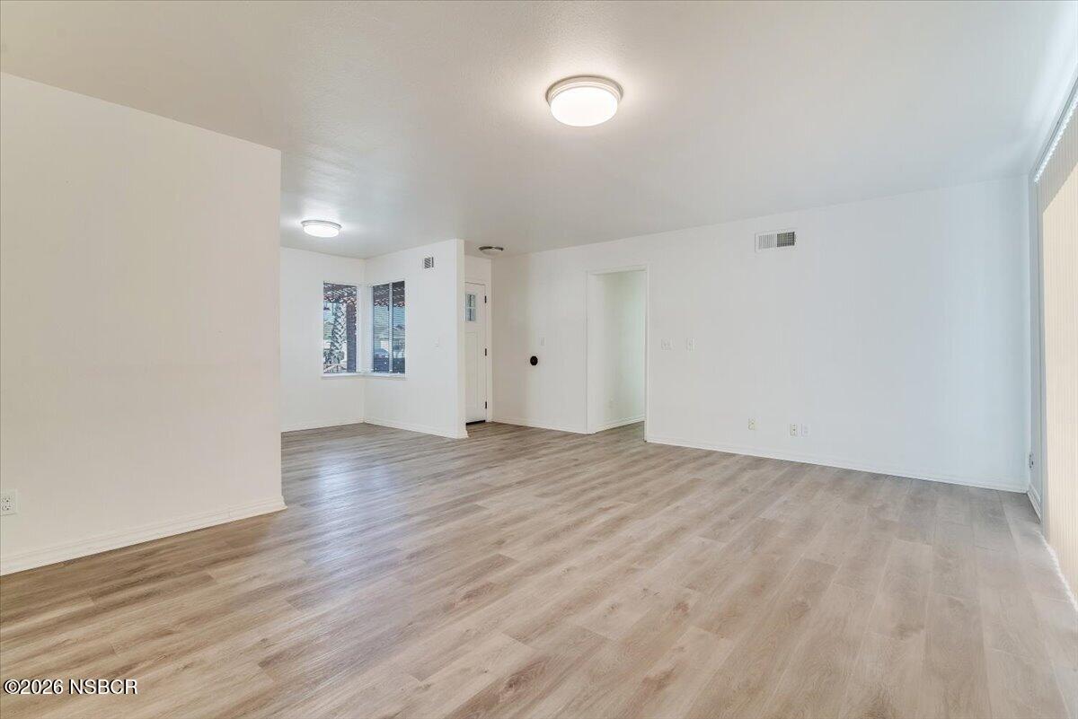 321 North Z Street Lompoc, CA 93436 - Photo 7 of 33 an empty room with wooden floor and windows