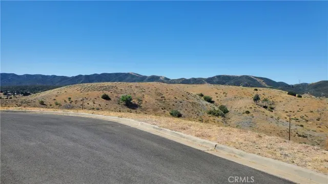 a view of a large mountain with mountains in the background