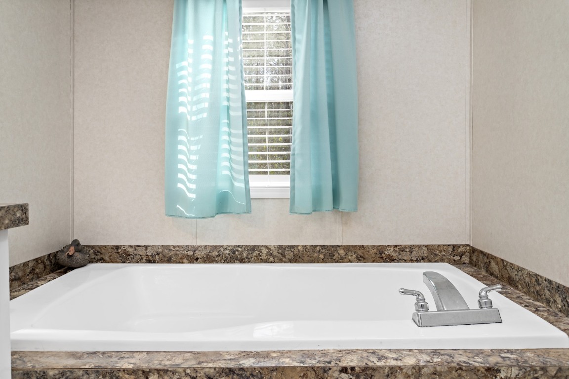 4943 Fm 770 Road Kountze, TX 77625 - Photo 13 of 15 a white bath tub sitting next to a window