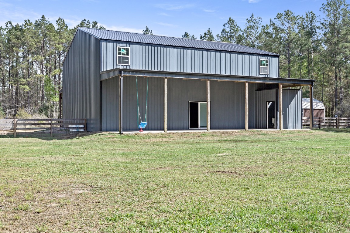 4943 Fm 770 Road Kountze, TX 77625 - Photo 4 of 15 a view of a house with a backyard