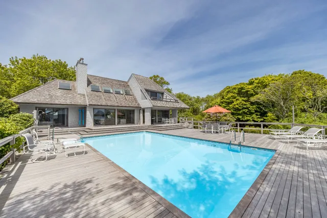 a view of a swimming pool with an outdoor seating and a yard