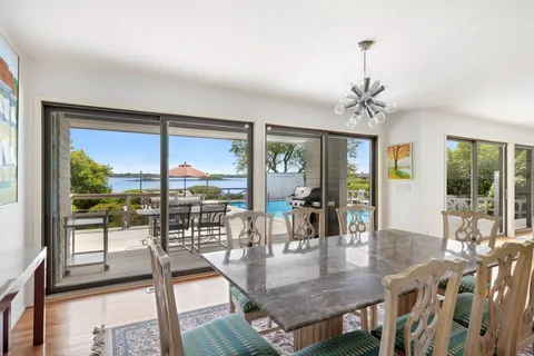 a kitchen with a sink and chairs