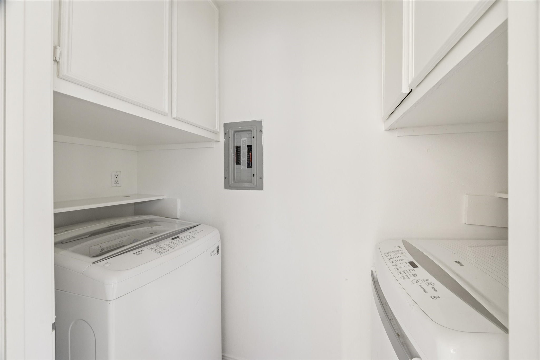 12 Lakeridge Drive Spring, TX 77381 - Photo 20 of 24 Functional main-floor laundry room with built-in cabinetry for extra storage, conveniently located near the kitchen.