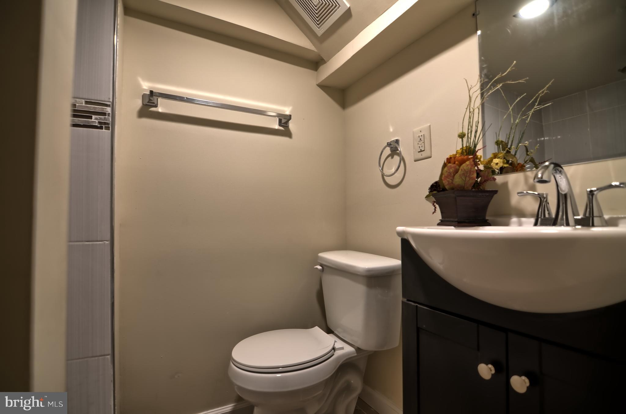 2603 Randolph Road Silver Spring, MD 20902 - Photo 21 of 26 a bathroom with a toilet sink and mirror