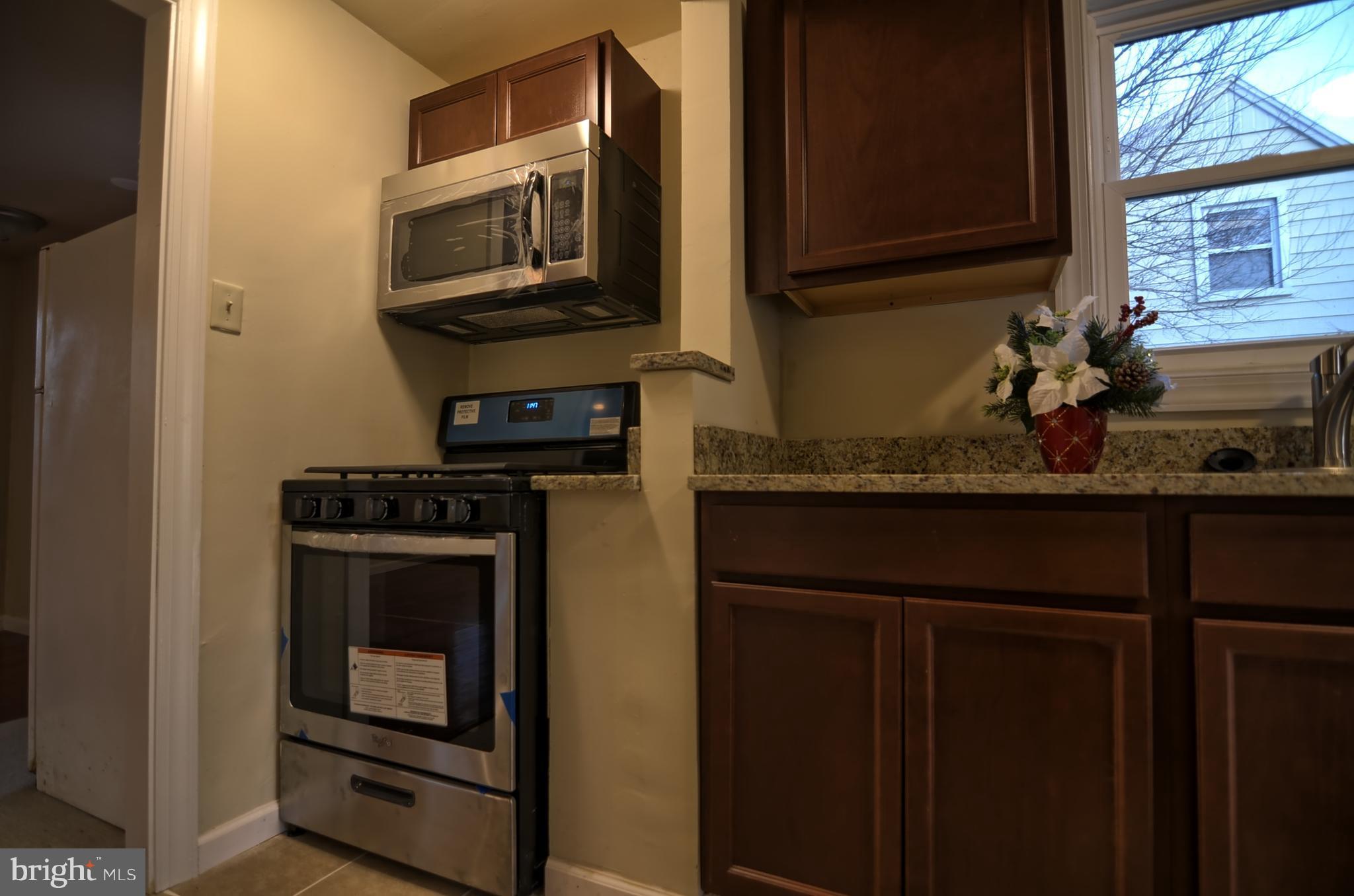 2603 Randolph Road Silver Spring, MD 20902 - Photo 23 of 26 a kitchen with a stove microwave and sink
