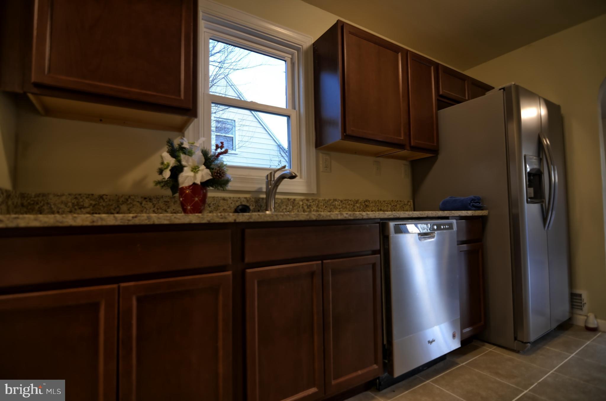2603 Randolph Road Silver Spring, MD 20902 - Photo 24 of 26 a kitchen with a sink a refrigerator and window