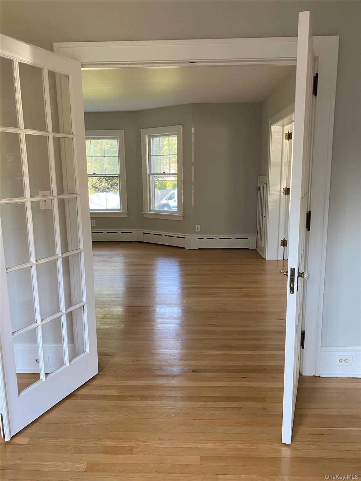 160 West Neck Road Huntington, NY 11743 - Photo 6 of 7 Empty room with light wood-style floors, baseboards, and baseboard heating