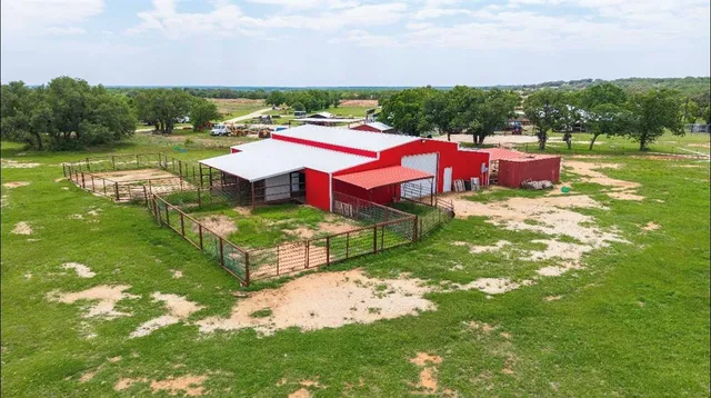 a view of a big yard with table and chairs