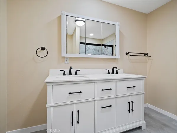 a bathroom with a sink vanity and a mirror