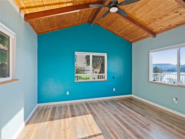 a view of a room with a window and wooden floor