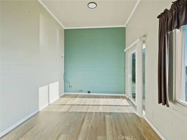 a view of a room with wooden floor and a window
