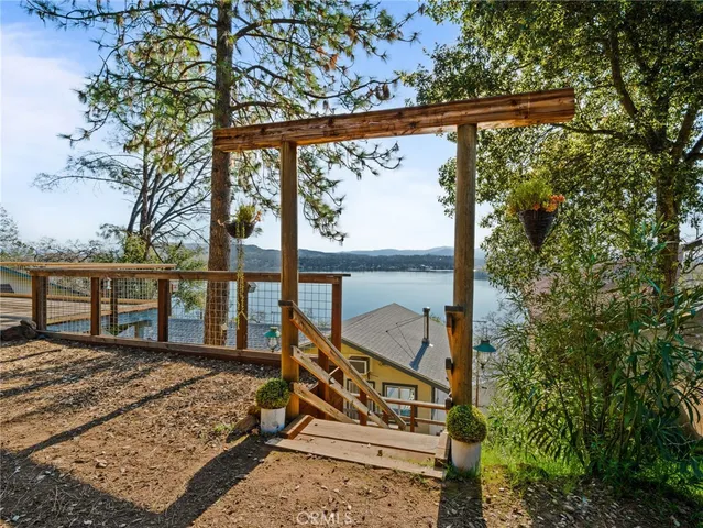 a view of a balcony with chairs and wooden fence