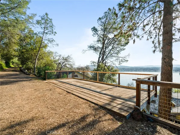 a view of a yard with wooden fence