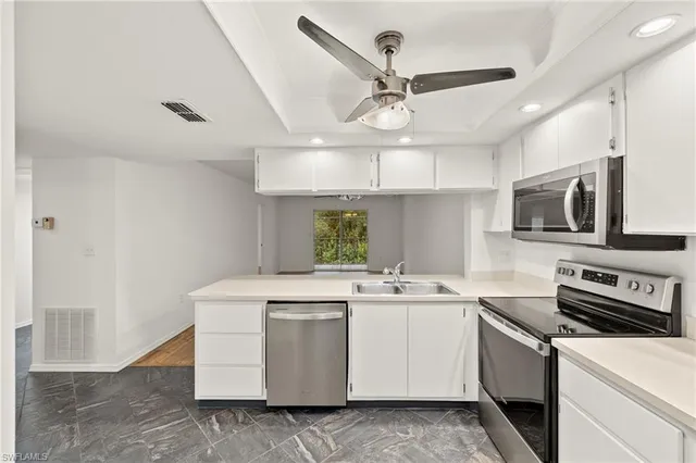 a kitchen that has a sink and a stove
