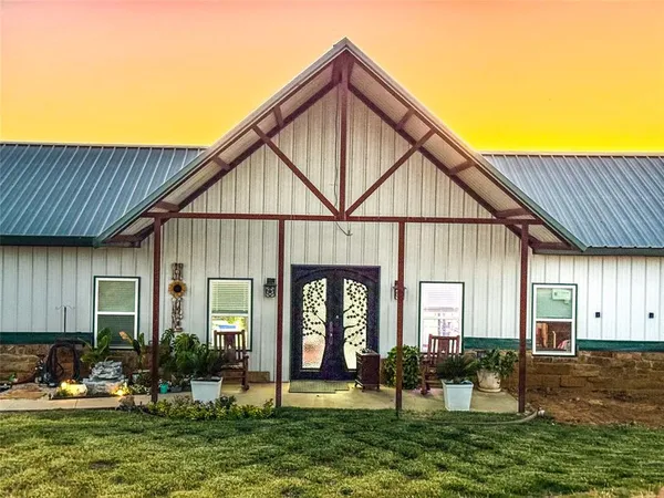 a front view of a house with yard and green space