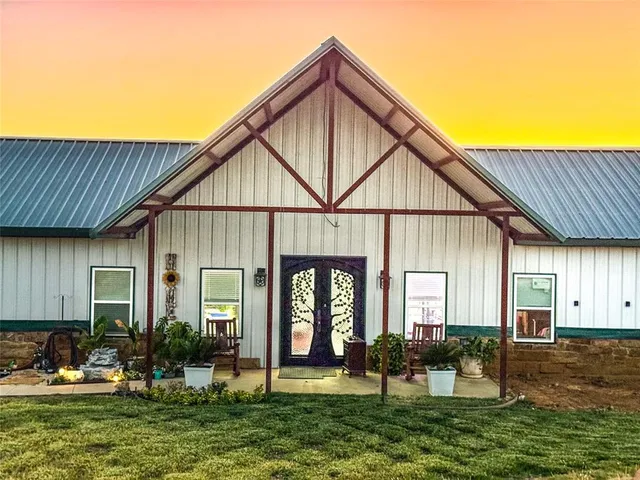 a front view of a house with yard and green space