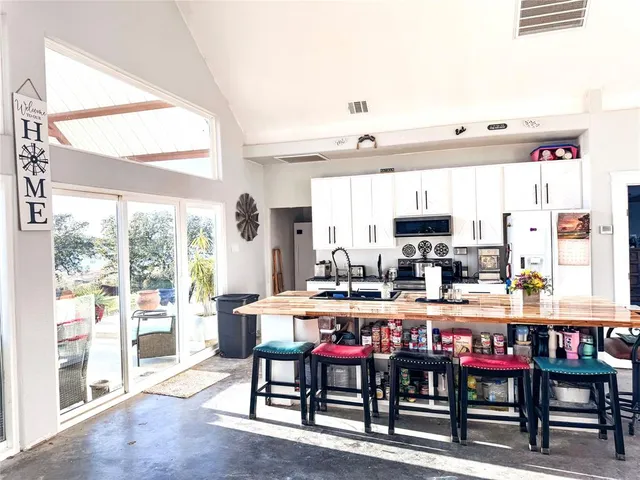 a view of a house with swimming pool and sitting area