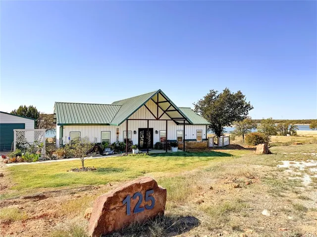 a room with stainless steel appliances kitchen island a large window in it