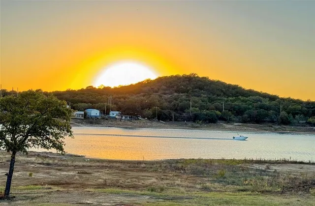 a spacious bedroom with a bed and a chandelier