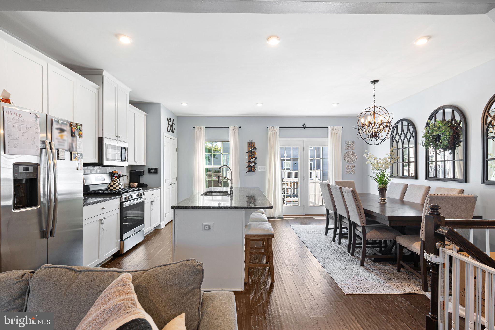 145 Meridian Lane Sewell, NJ 08080 - Photo 4 of 15 a kitchen with stainless steel appliances granite countertop a stove a refrigerator a kitchen island a dining table and chairs