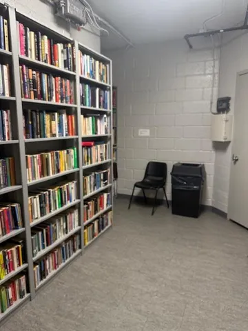 a room with a book shelf and a book shelf