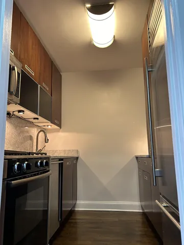 a kitchen with a sink a stove and cabinets