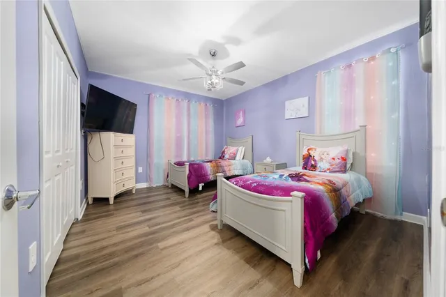 a spacious bedroom with a bed and a chandelier