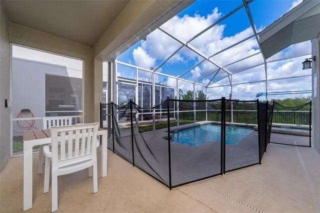 an aerial view of a house with a swimming pool patio and outdoor seating