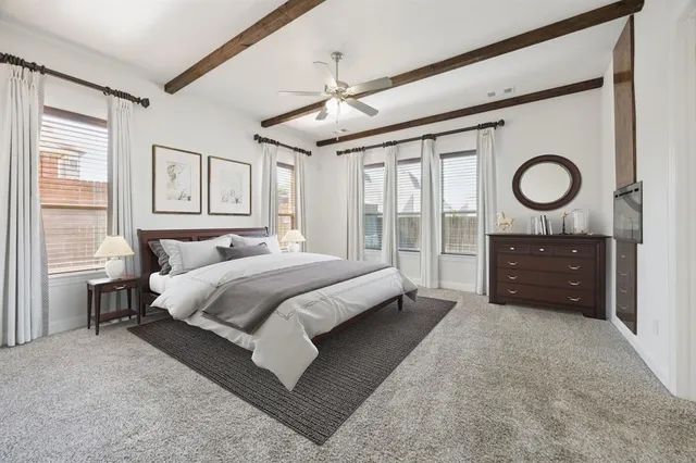 a spacious bedroom with a bed and window