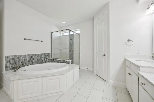 a bathroom with a bathtub and a sink