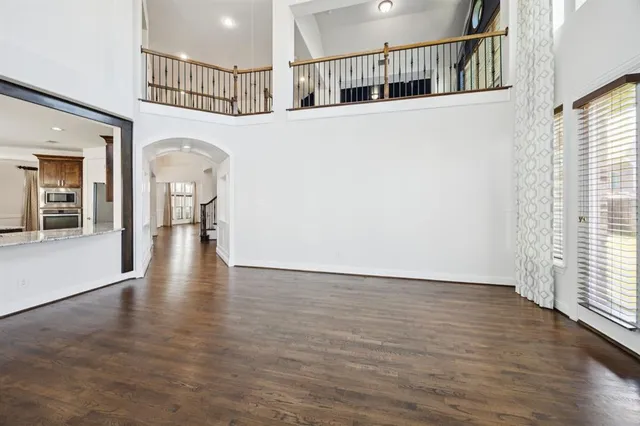 wooden floor in an empty room with a window and wooden floor