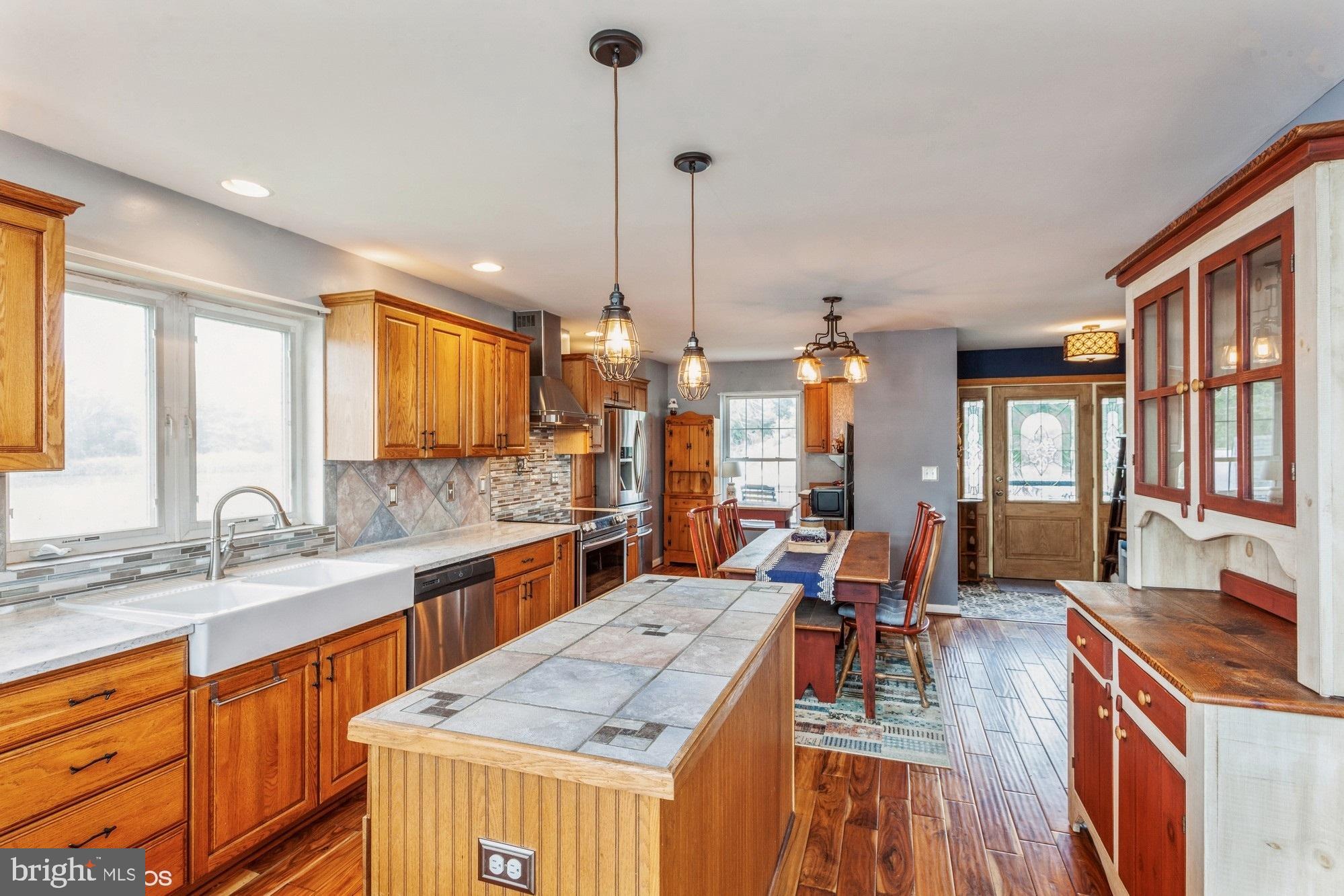 2425 Golupski Road Essex, MD 21221 - Photo 6 of 48 a large kitchen with kitchen island granite countertop a large center island and a sink