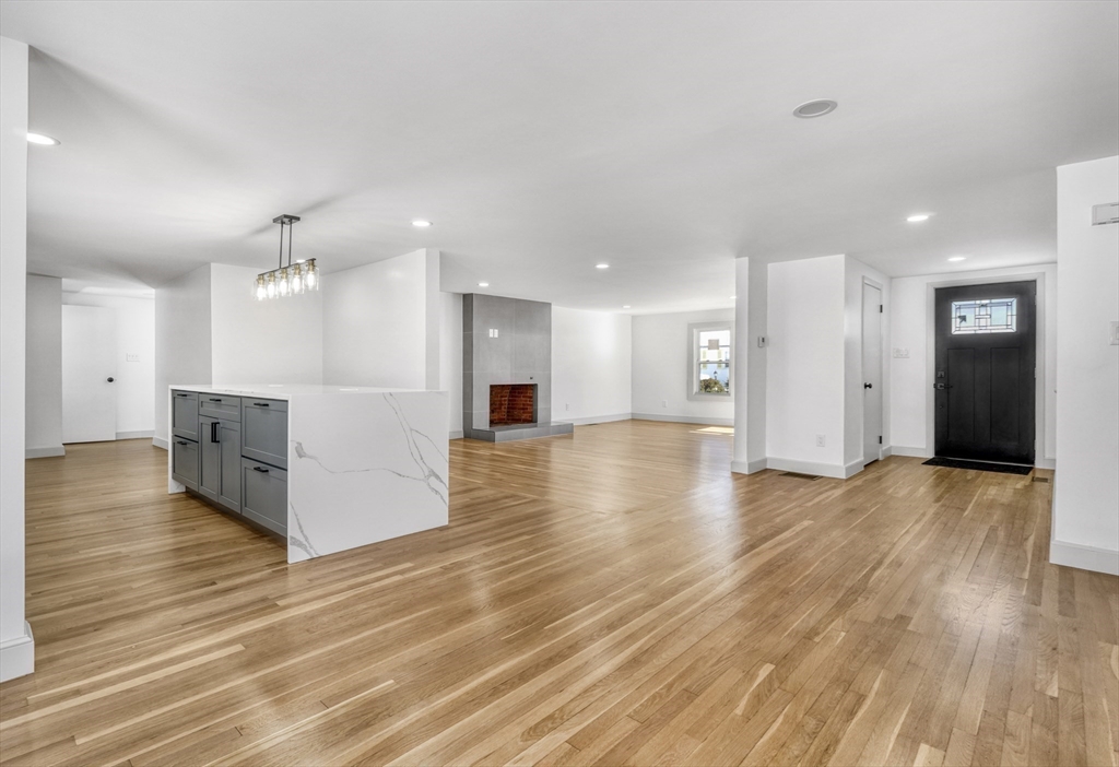 6 Spring Lane Saugus, MA 01906 - Photo 13 of 37 a view of a big room with wooden floor and a kitchen