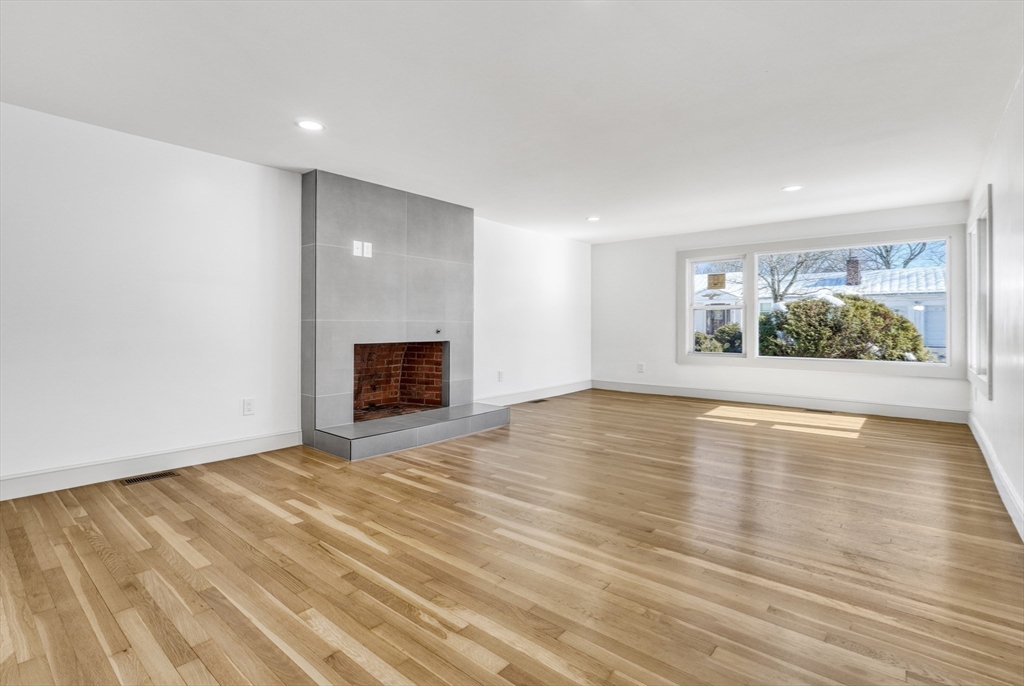 6 Spring Lane Saugus, MA 01906 - Photo 14 of 37 an empty room with wooden floor and windows