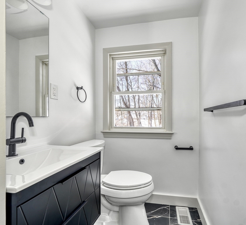 6 Spring Lane Saugus, MA 01906 - Photo 16 of 37 a bathroom with a sink a toilet and a mirror