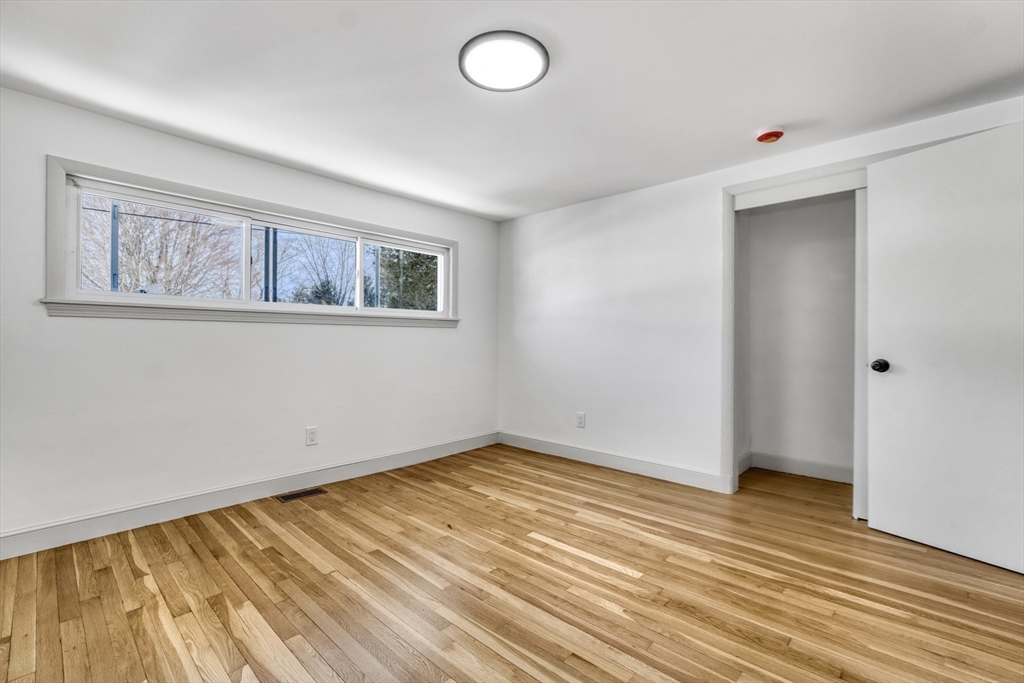 6 Spring Lane Saugus, MA 01906 - Photo 18 of 37 a view of an empty room with wooden floor and a window