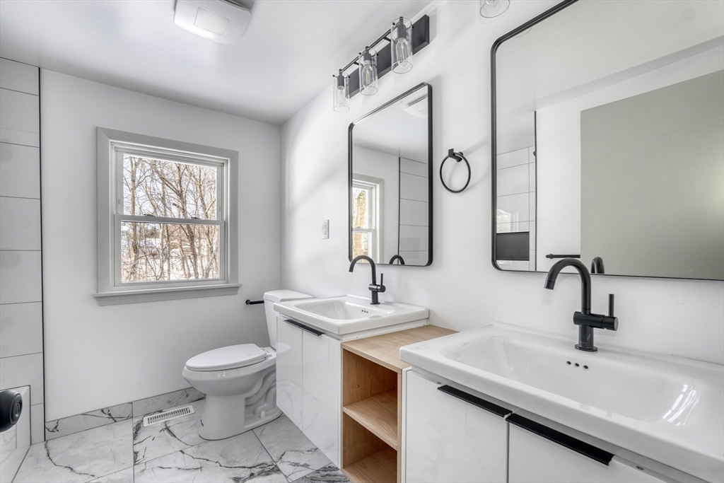 6 Spring Lane Saugus, MA 01906 - Photo 19 of 37 a bathroom with a double vanity sink mirror and toilet