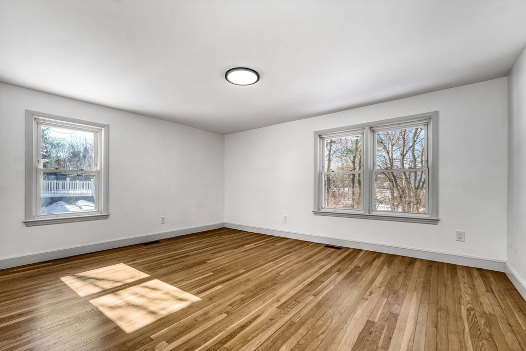 6 Spring Lane Saugus, MA 01906 - Photo 25 of 37 a view of an empty room with a window and wooden floor