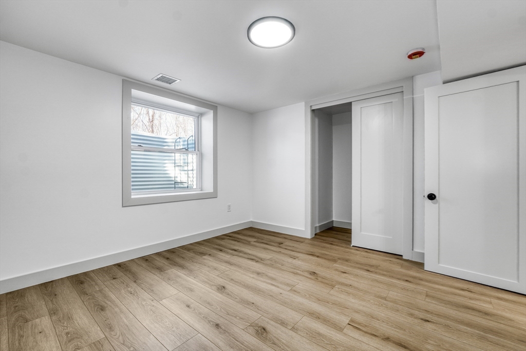 6 Spring Lane Saugus, MA 01906 - Photo 26 of 37 an empty room with wooden floor and windows