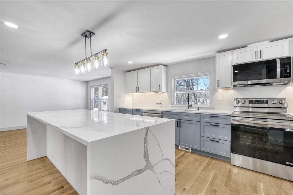 6 Spring Lane Saugus, MA 01906 - Photo 3 of 37 a kitchen with a sink stove and microwave