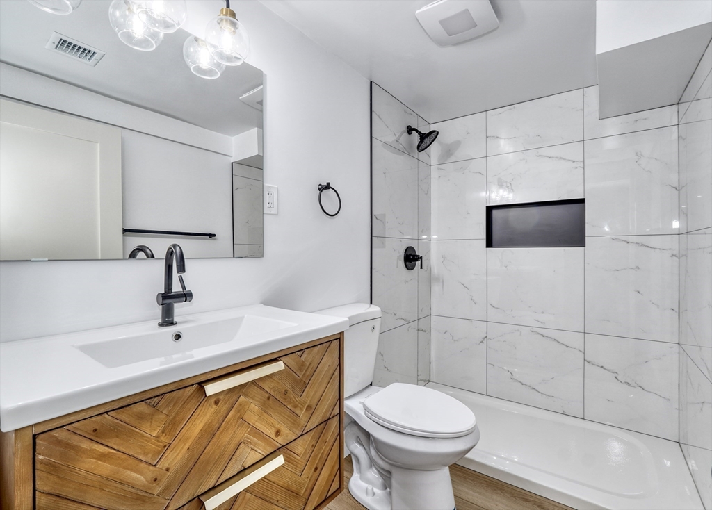 6 Spring Lane Saugus, MA 01906 - Photo 32 of 37 a bathroom with a sink toilet and shower