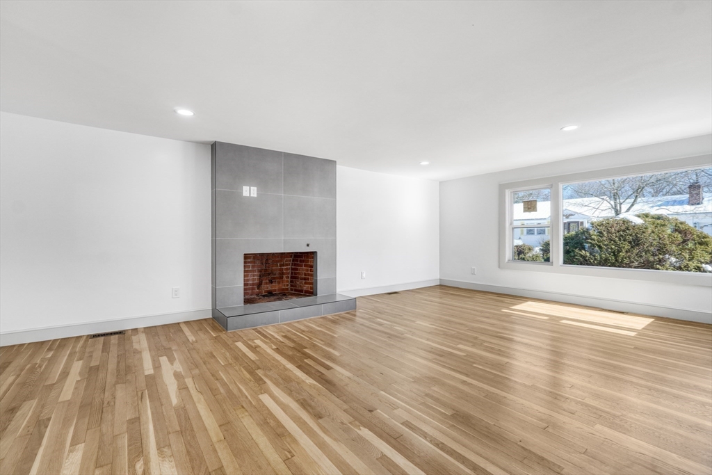 6 Spring Lane Saugus, MA 01906 - Photo 10 of 37 a view of an empty room with a window and fire place