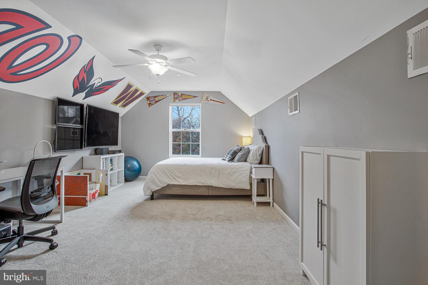703 Trapper Way Deale, MD 20751 - Photo 15 of 18 a spacious bedroom with a bed and a chandelier