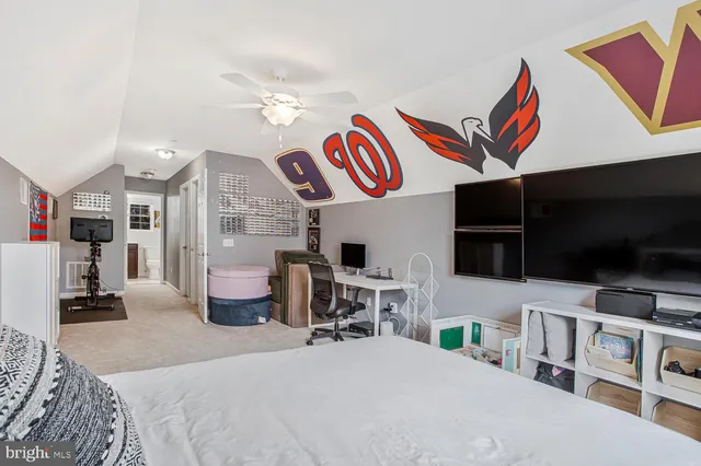 a bedroom with furniture and a flat screen tv