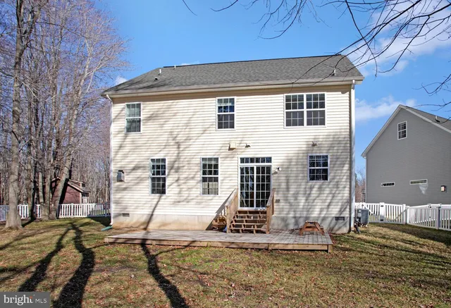 a view of a house with wooden fence